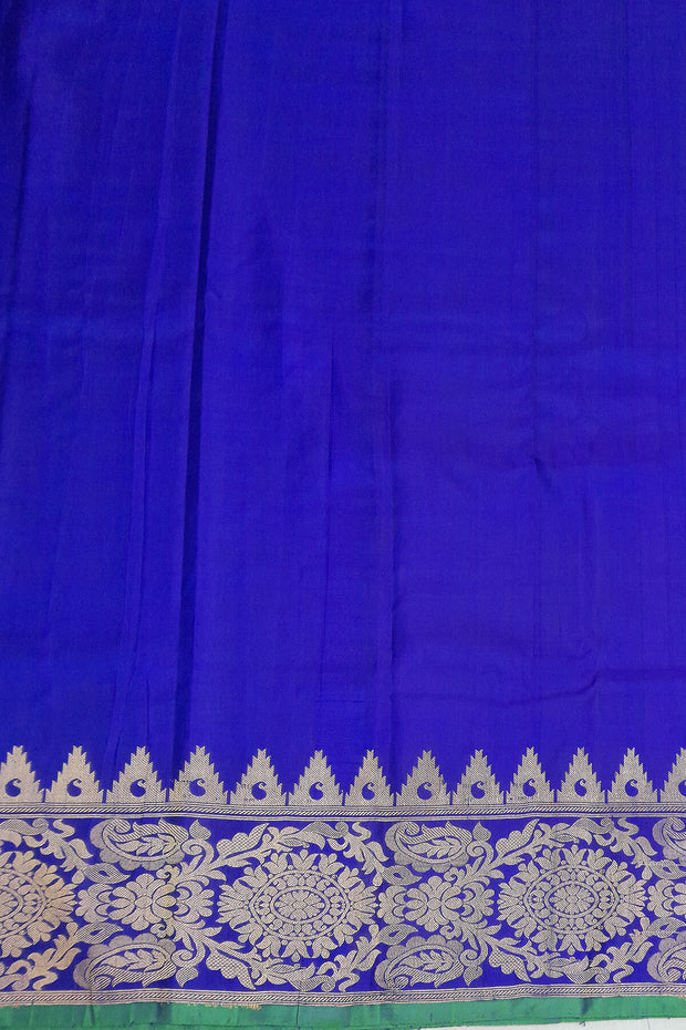 Handwoven Gadwal pure silk saree in purple with floral motifs all over the body.