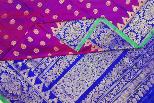 Handwoven Gadwal pure silk saree in purple with floral motifs all over the body.