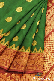 Handwoven Gadwal pure silk saree in bottle green with gold motifs