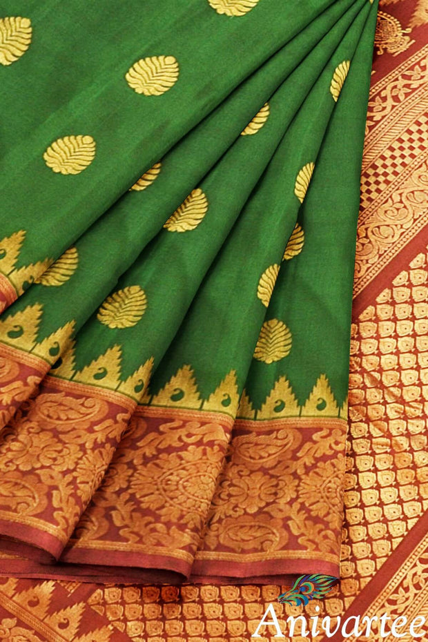 Handwoven Gadwal pure silk saree in bottle green with gold motifs