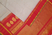 Handwoven Gadwal pure silk saree in off white with fine checks and gold buttis.