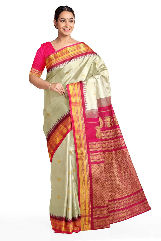 Handwoven Gadwal pure silk saree in cream with  gold buttis.