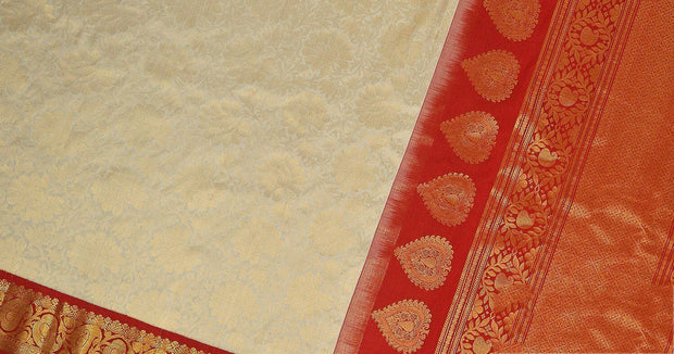 Handwoven Gadwal silk brocade saree in off white with floral motifs on the body