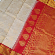 Handwoven Gadwal silk brocade saree in off white with floral motifs on the body