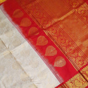 Handwoven Gadwal silk brocade saree in off white with floral motifs on the body