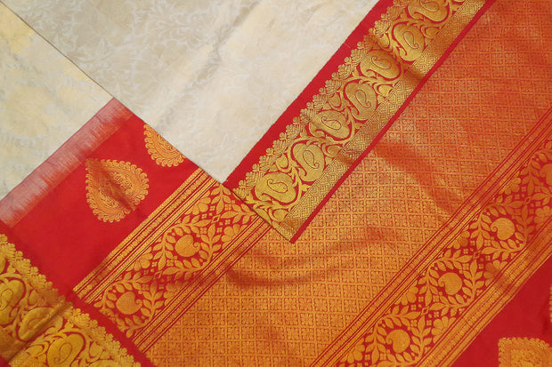 Handwoven Gadwal silk brocade saree in off white with floral motifs on the body