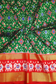 Handwoven Ikat pure silk unstitched lehenga material in bottle green  in navratan pattern