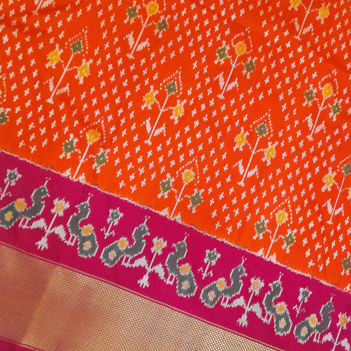 Handwoven Ikat pure silk unstitched lehenga material in orange  with plant motifs.