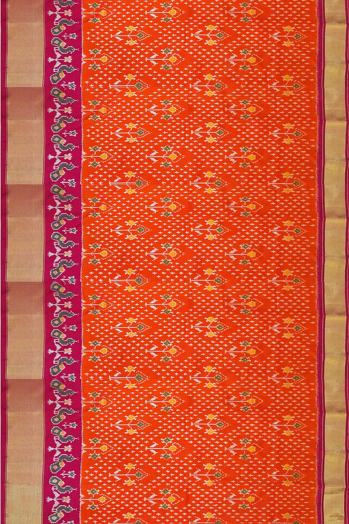 Handwoven Ikat pure silk unstitched lehenga material in orange  with plant motifs.