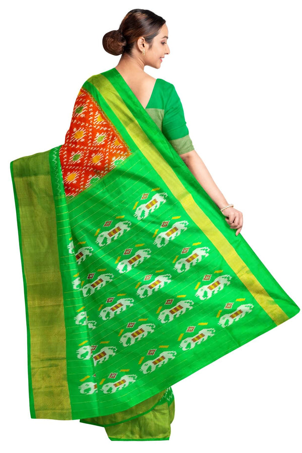 Ikat pure silk saree in orange in diamond pattern with elephant motifs in zari border & pallu.