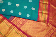 Handwoven Kanchi pure silk saree in dual tone blue with silver motifs.