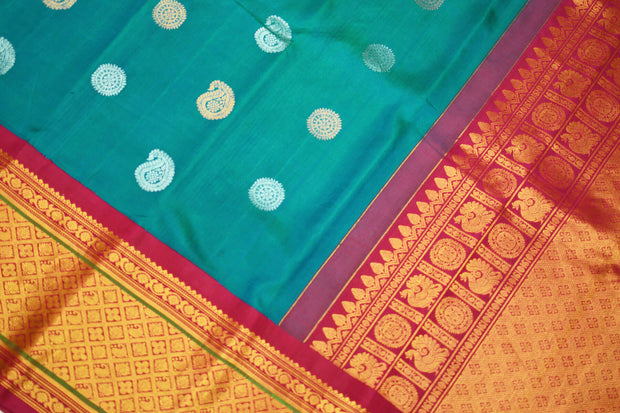 Handwoven Kanchi pure silk saree in dual tone blue with silver motifs.