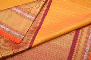 Handwoven Kanchi pure silk  brocade saree in mustard , accentuated with peacock motifs in the border