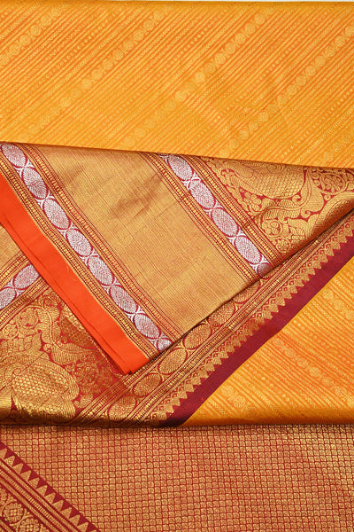 Handwoven Kanchi pure silk  brocade saree in mustard , accentuated with peacock motifs in the border