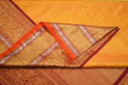 Handwoven Kanchi pure silk  brocade saree in mustard , accentuated with peacock motifs in the border