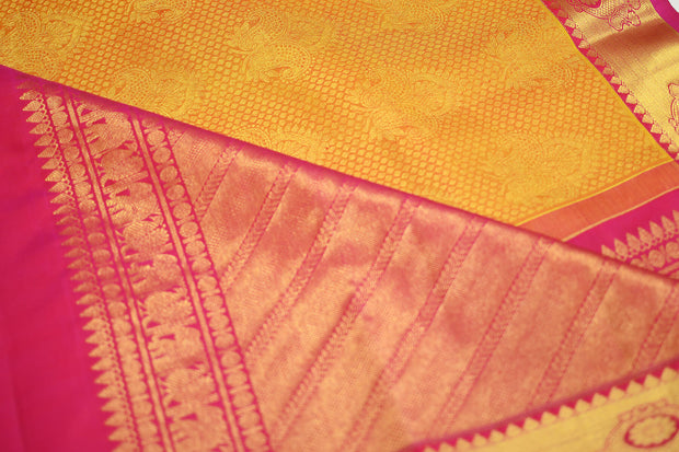 Kanchi silk brocade saree in yellow with contrast pallu in pink