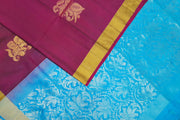 Kanchi pure silk saree in wine with floral motifs on the body.