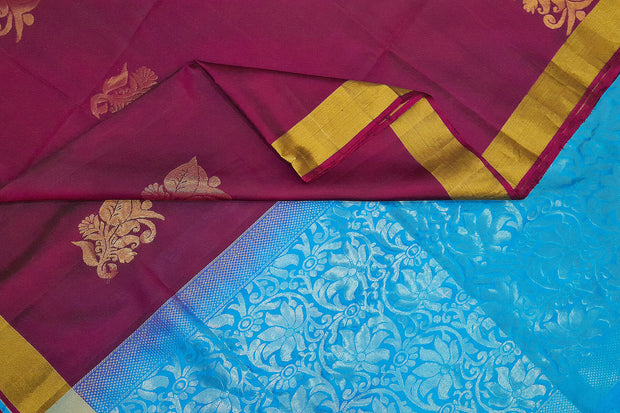 Kanchi pure silk saree in wine with floral motifs on the body.