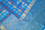 Kanchi pure silk saree in blue with floral motifs .