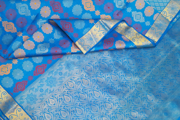 Kanchi pure silk saree in blue with floral motifs .