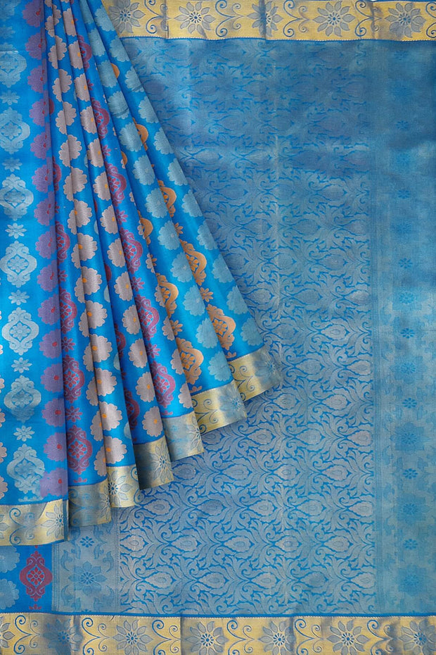 Kanchi pure silk saree in blue with floral motifs .