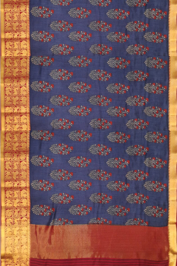 An  electric blue shade moonga silk saree with  copper red weaved zari border.