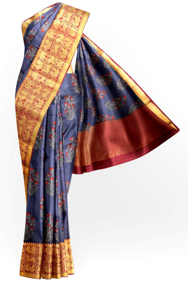 An  electric blue shade moonga silk saree with  copper red weaved zari border.