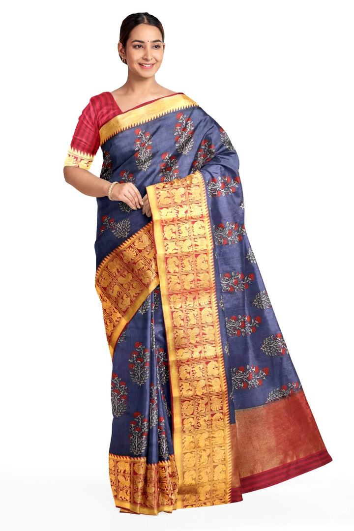 An  electric blue shade moonga silk saree with  copper red weaved zari border.