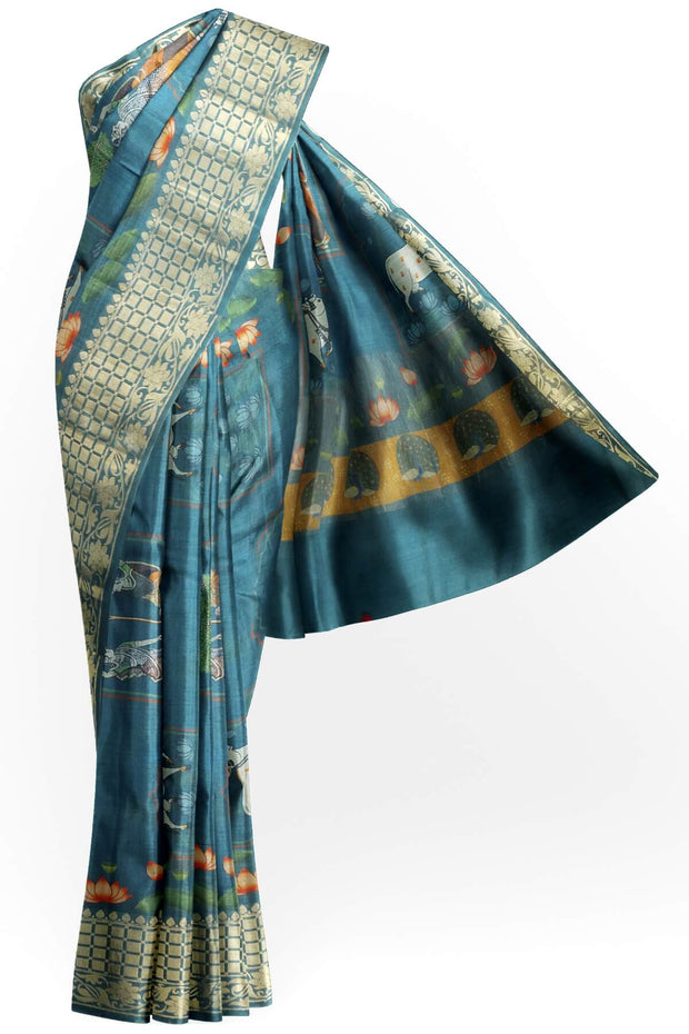 The pichwai with cow and lotus motifs .The gorgeous moonga saree has beautiful handwoven zari  borders