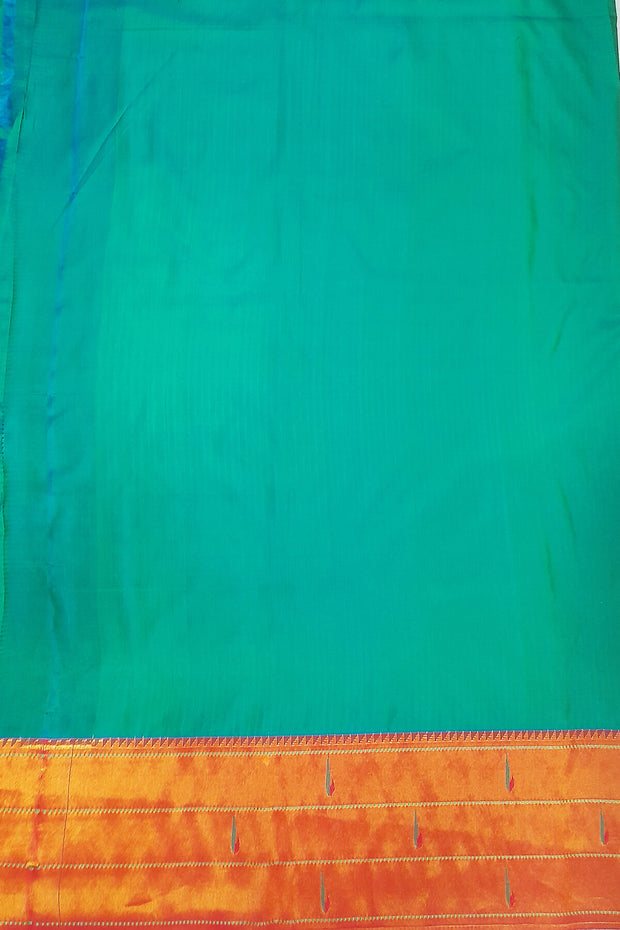 Paithani pure silk saree in teal green with small buttis all over the body and with colourful lotus motifs in gold pallu.