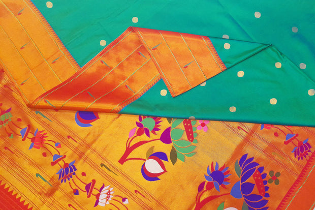 Paithani pure silk saree in teal green with small buttis all over the body and with colourful lotus motifs in gold pallu.