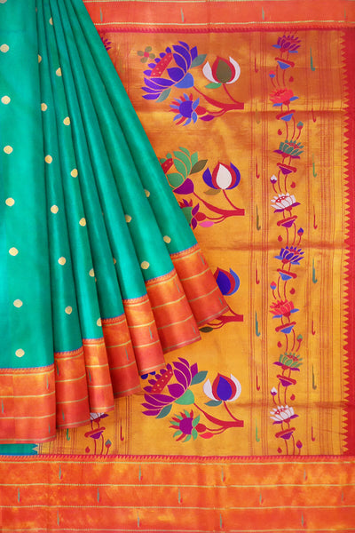 Paithani pure silk saree in teal green with small buttis all over the body and with colourful lotus motifs in gold pallu.