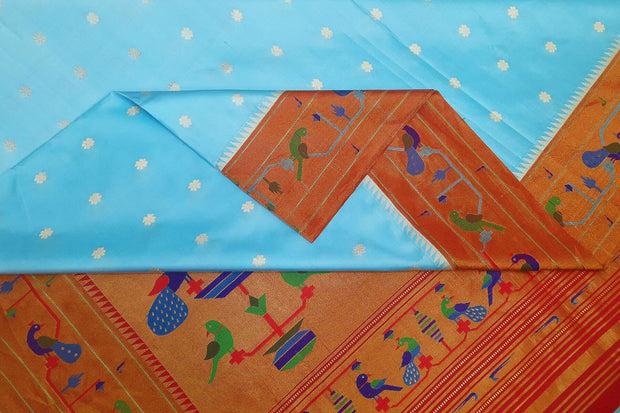 Paithani pure silk saree in sky blue  with small buttis all over the body and with colourful parrot &  peacock  motifs in  pallu.