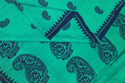 Printed pure silk saree in teal green with paisley motifs all over.