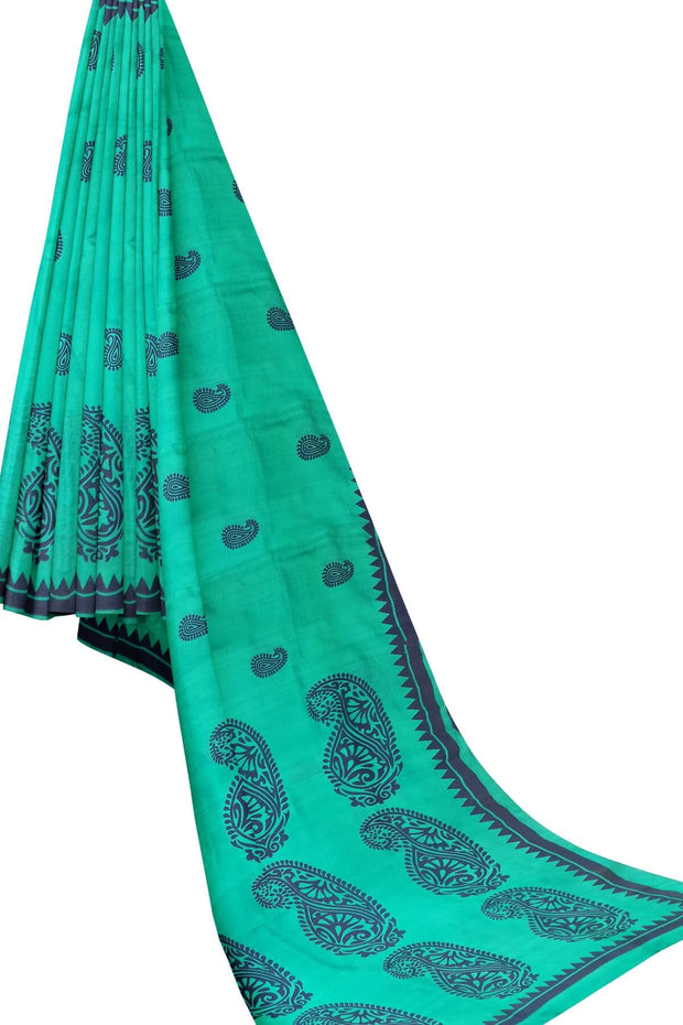 Printed pure silk saree in teal green with paisley motifs all over.