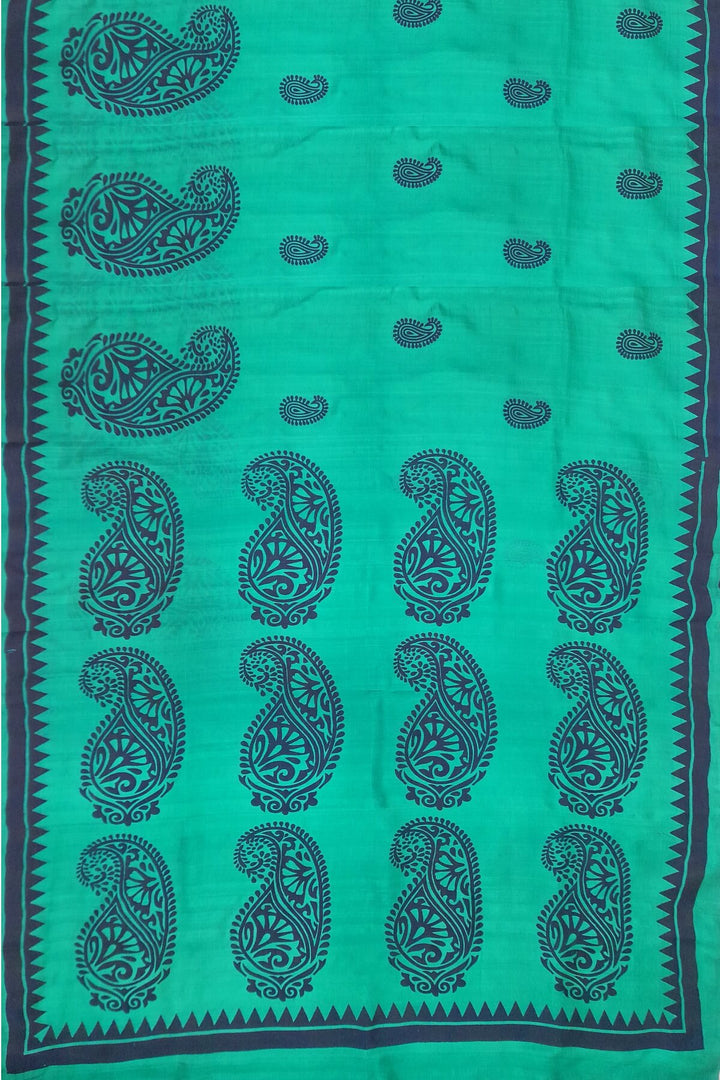 Printed pure silk saree in teal green with paisley motifs all over.