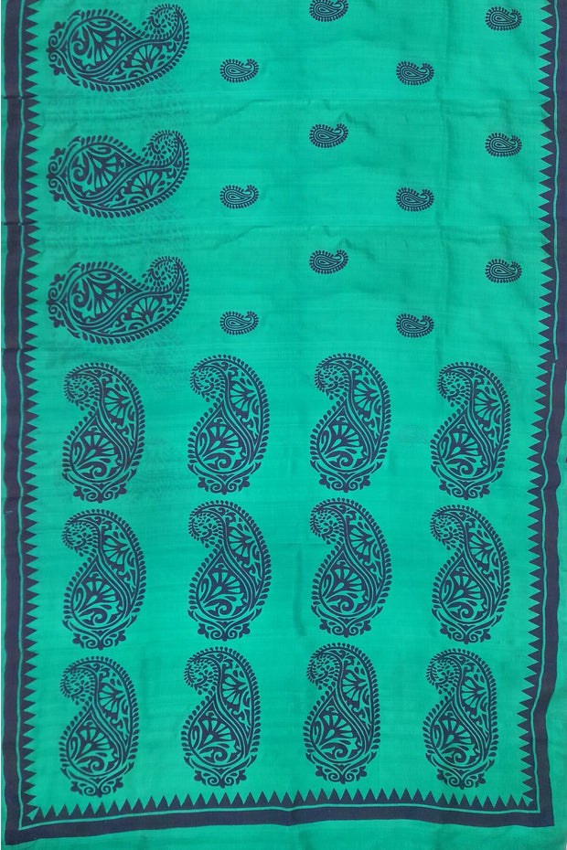 Printed pure silk saree in teal green with paisley motifs all over.